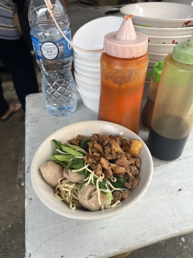 お椀に入ったバクソ。麺の上に肉団子と鶏肉、青菜がのっている